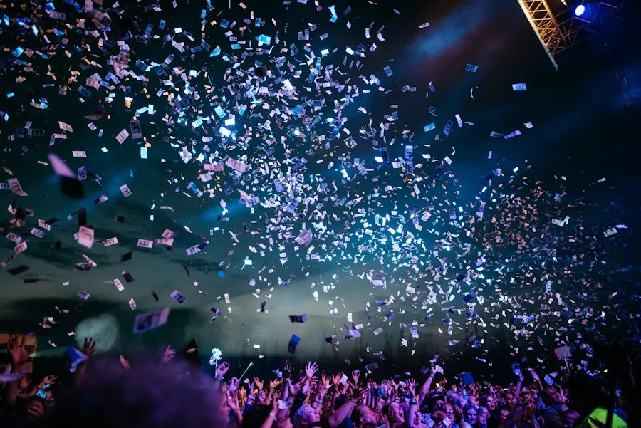 Concert crowd silhouettes against bright stage lights